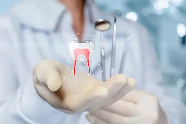 Futuristic rendering of tooth with roots in dentist's hand