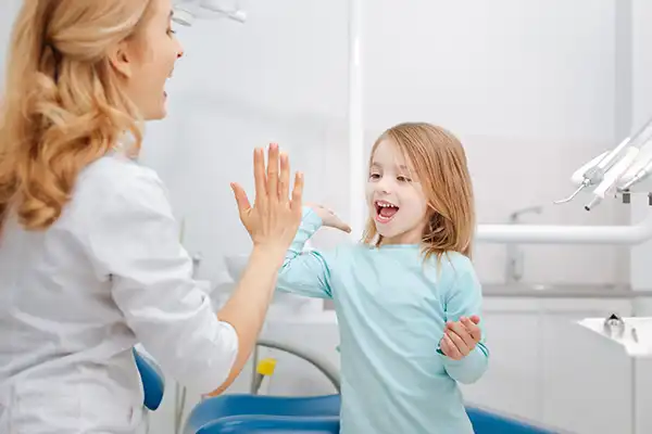 Dentist giving child patient a high five