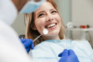 White female patient happily waiting in a dental chair for her dentist to begin her routine dental exam at Artistic Dental