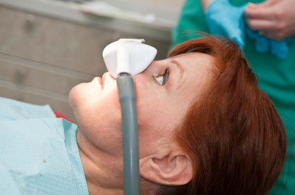 Older woman with a mask on for sedation dental work.