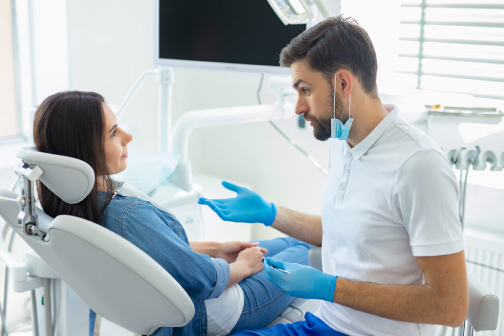 side view of dentist talking with client in hopital