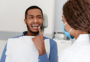 Dentist explaining tooth pain and treatment options to a patient